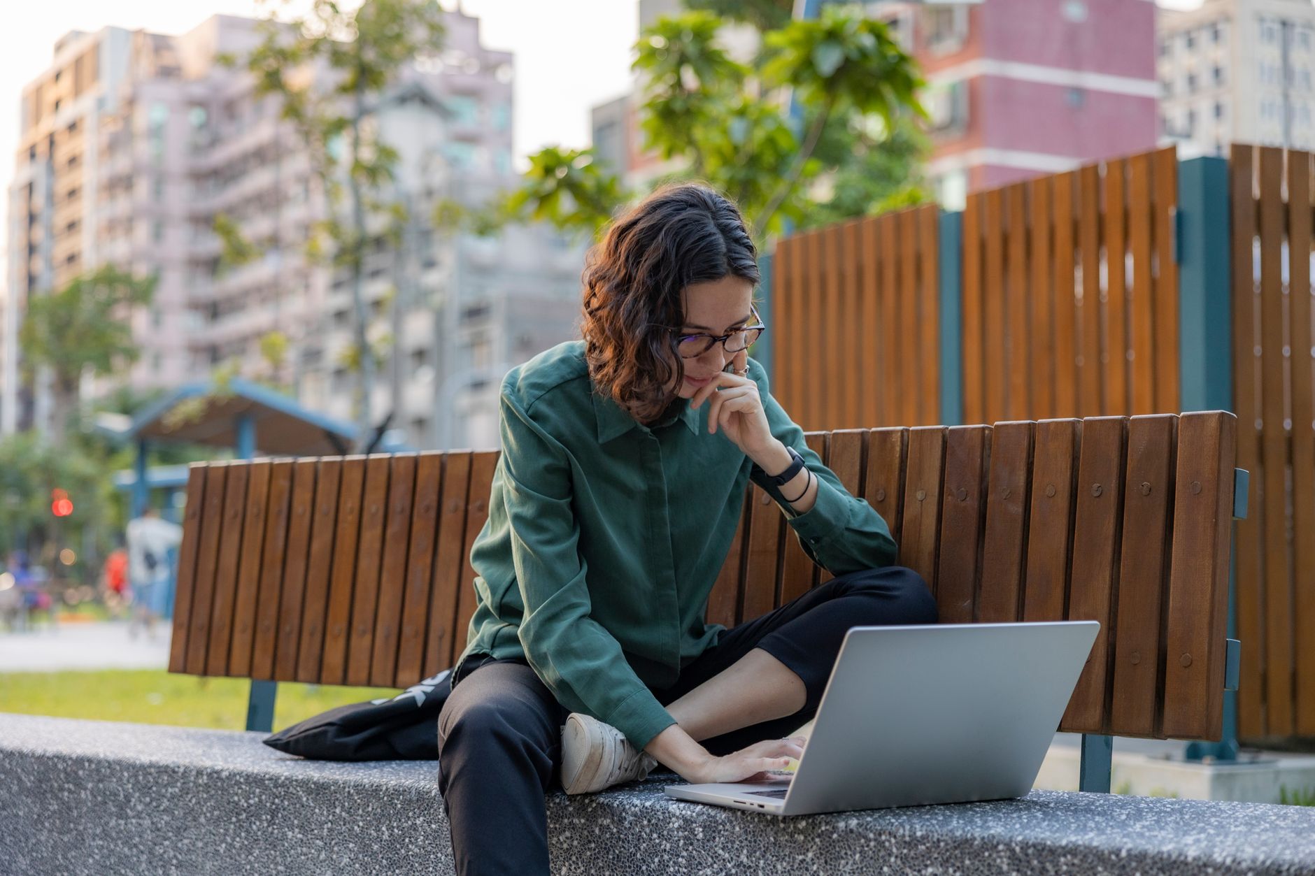 a woman sitting with a laptop