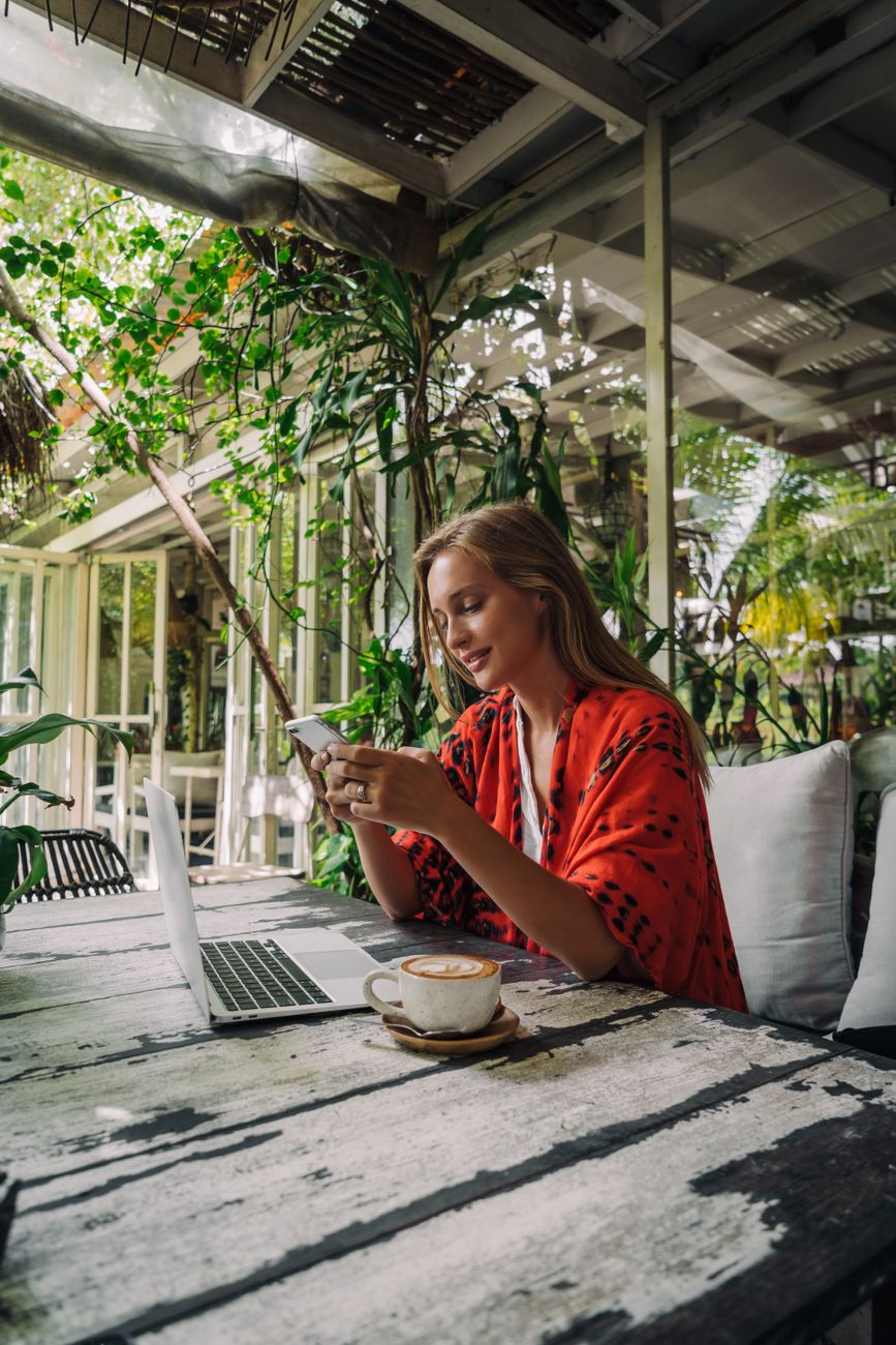 woman in orange robe texting